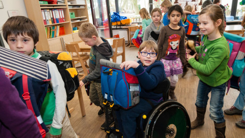 DY9JF3 Non-disabled and disabled students (in this case a boy in a wheel chair) learn together in the same class in a primary school. 